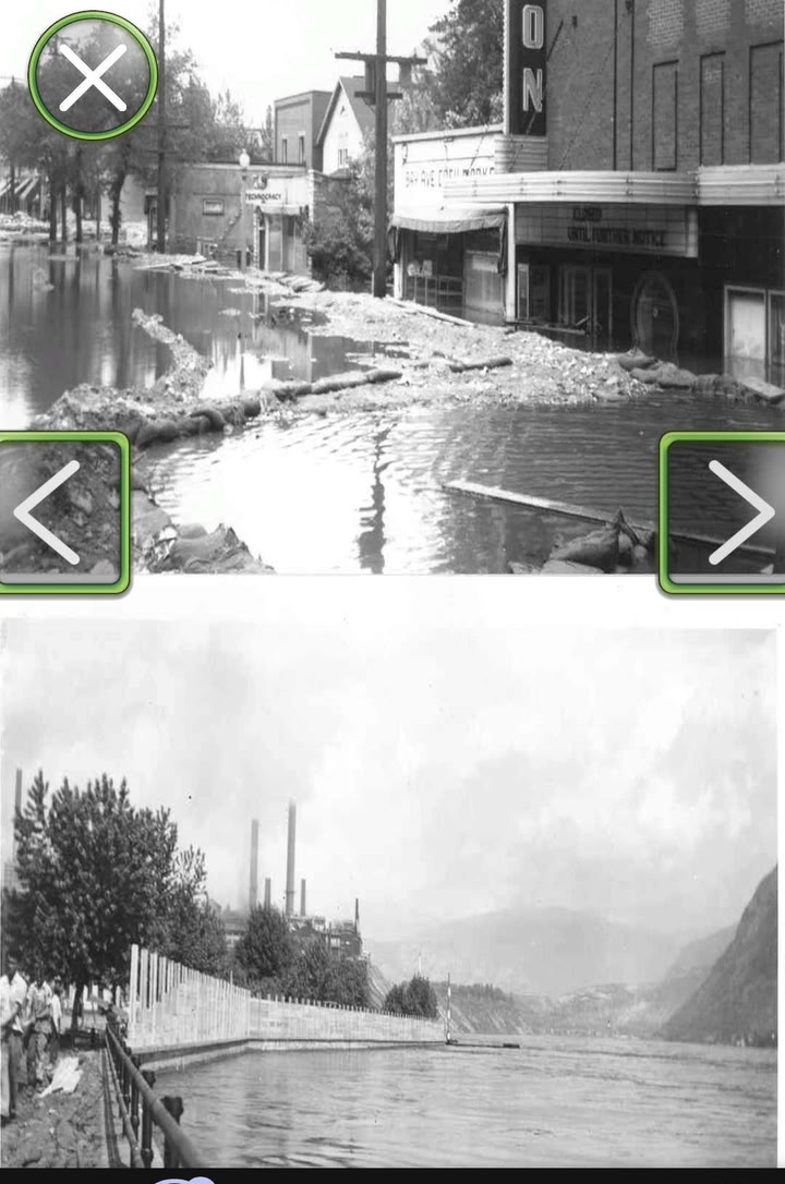 Archival photograph in the AR experience: Trail's main street under water past the storefronts, above the flooded rail line running beside the Columbia River.