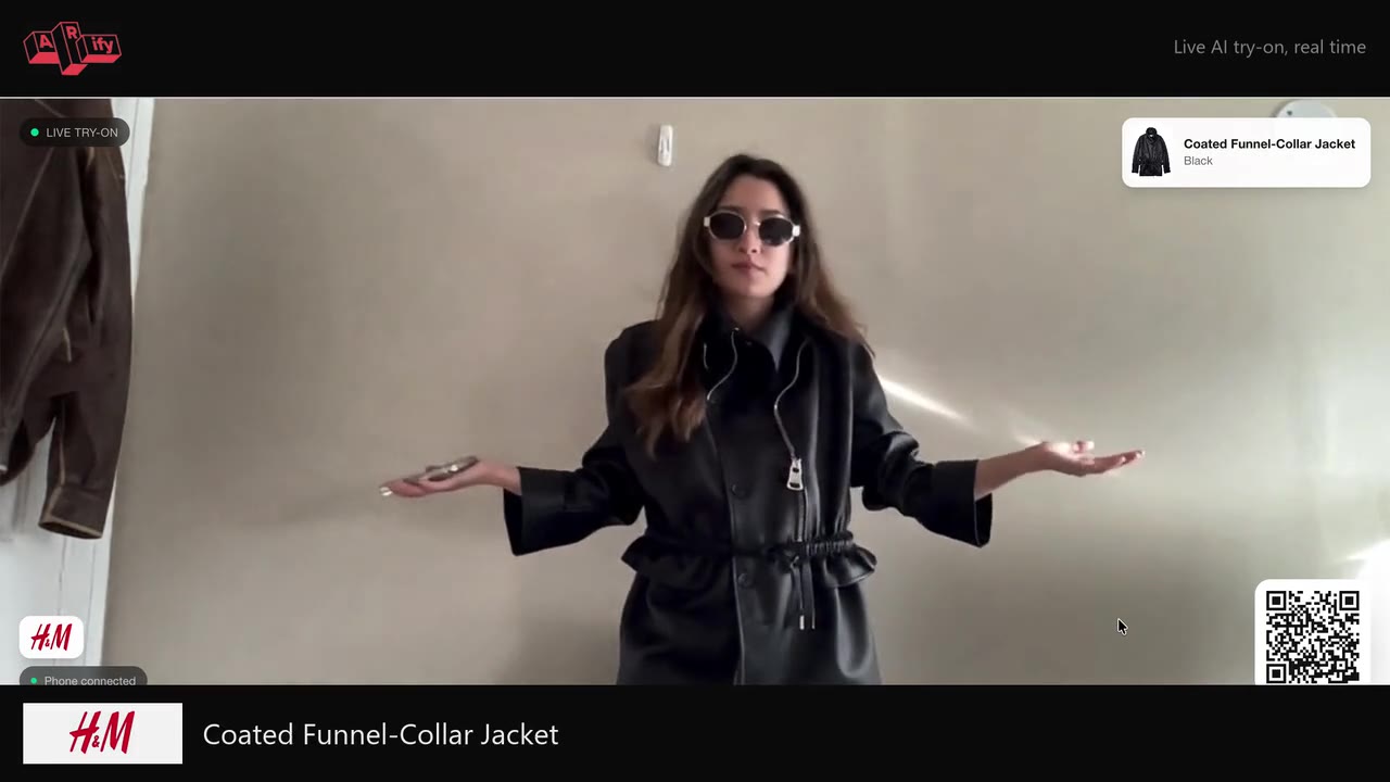 The same shopper a moment later in a coated funnel-collar jacket — the AI swaps the garment live.